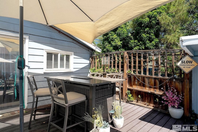 wooden terrace featuring outdoor dining space