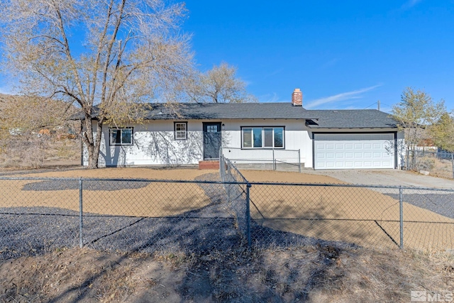 ranch-style home featuring a garage, a chimney, driveway, and a fenced front yard