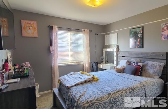 bedroom with baseboards and carpet flooring