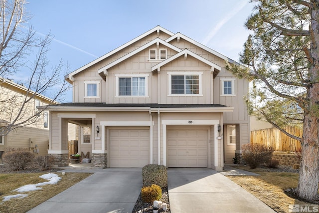 craftsman house featuring board and batten siding, driveway, a garage, and fence