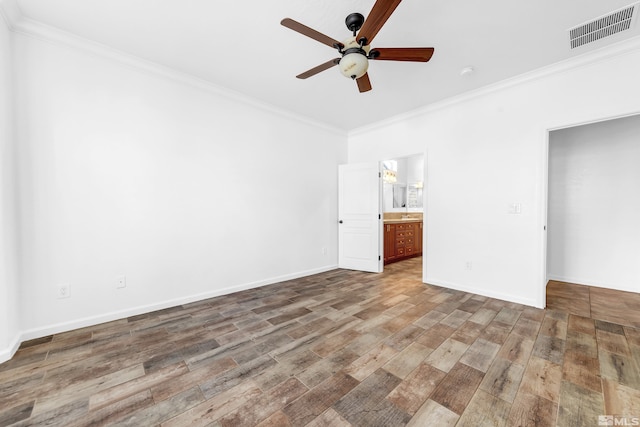 unfurnished bedroom featuring visible vents, crown molding, baseboards, and wood finished floors