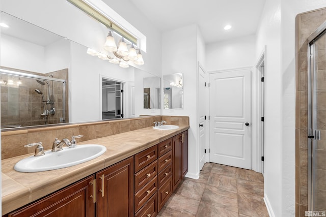 bathroom with a stall shower, a sink, recessed lighting, and double vanity