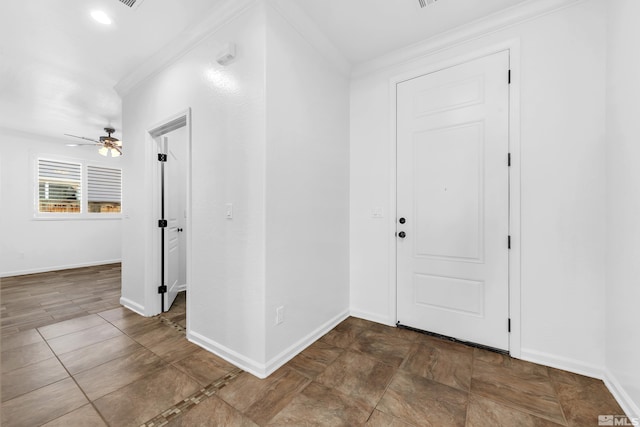 foyer entrance with ornamental molding, baseboards, and a ceiling fan