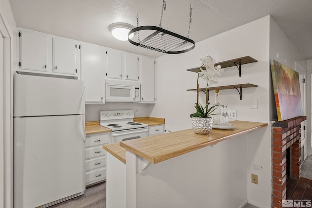 kitchen featuring light countertops, white appliances, open shelves, and white cabinetry