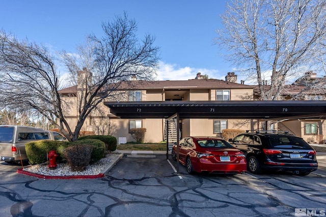 covered parking lot featuring stairs