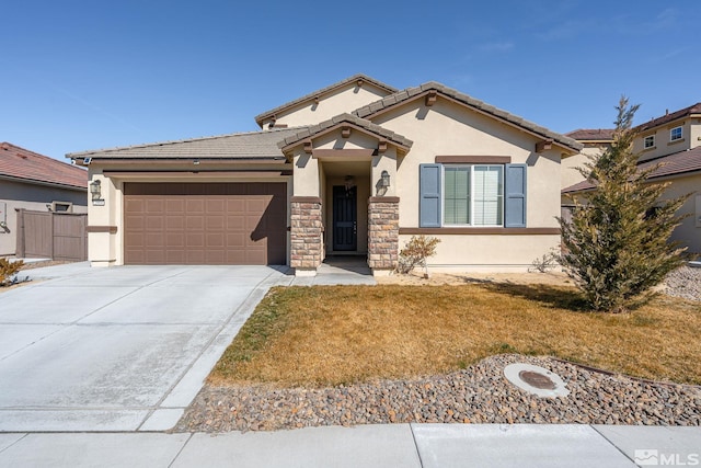 view of front of home with an attached garage, a tile roof, driveway, stone siding, and stucco siding