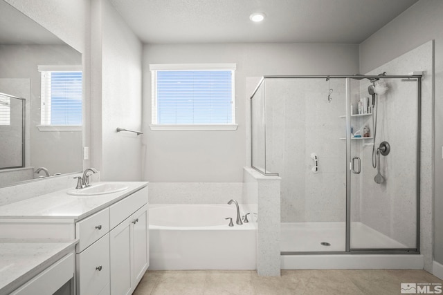 bathroom featuring a bath, a shower stall, vanity, and tile patterned floors