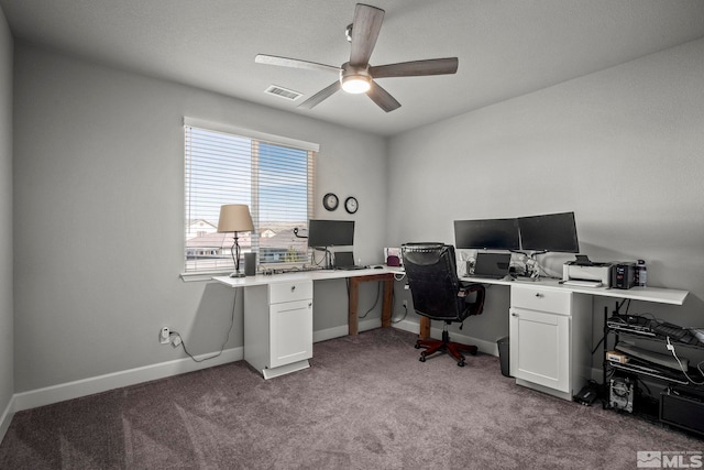 carpeted office featuring ceiling fan, visible vents, and baseboards