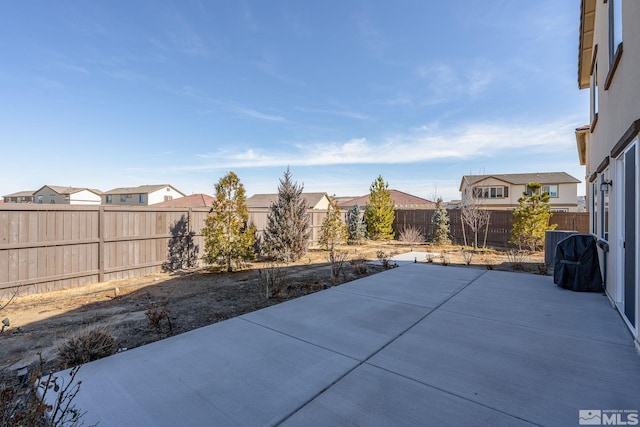 view of patio with a residential view and a fenced backyard