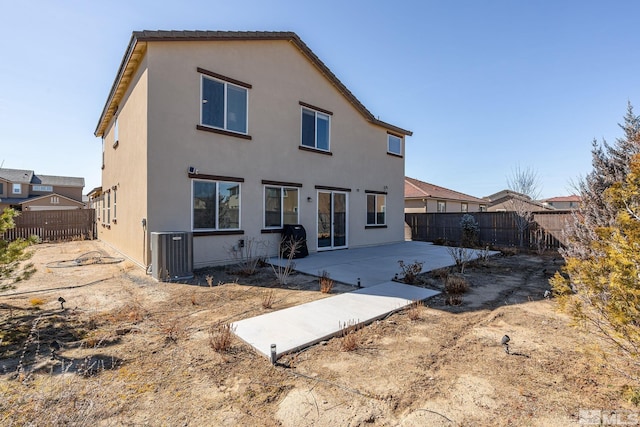 back of property featuring a patio area, a fenced backyard, cooling unit, and stucco siding