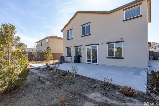 back of property with a patio area, fence, and stucco siding