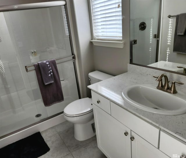 full bathroom featuring toilet, a shower stall, tile patterned flooring, and vanity