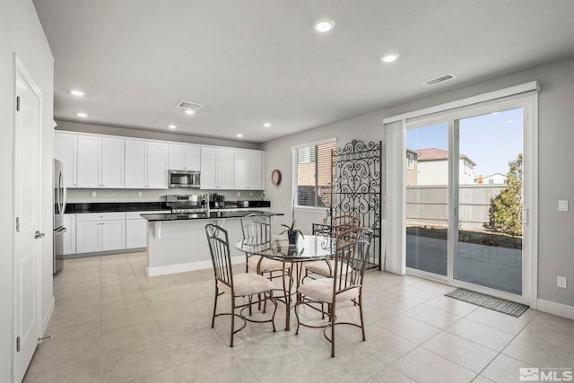 dining space featuring light tile patterned floors, baseboards, visible vents, and recessed lighting