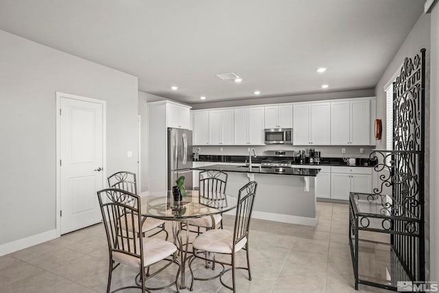 dining area featuring recessed lighting, visible vents, baseboards, and light tile patterned flooring