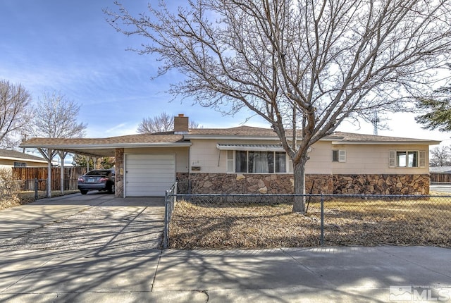 single story home featuring an attached carport, a garage, stone siding, driveway, and a chimney