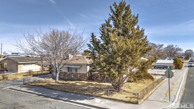 view of front of house with concrete driveway and fence