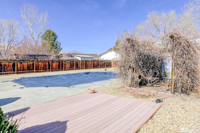 view of swimming pool featuring fence private yard, a fenced in pool, and a wooden deck