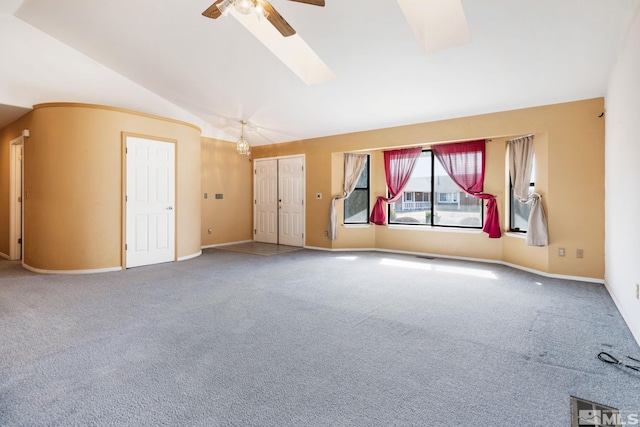 spare room with carpet floors, baseboards, vaulted ceiling, and a ceiling fan