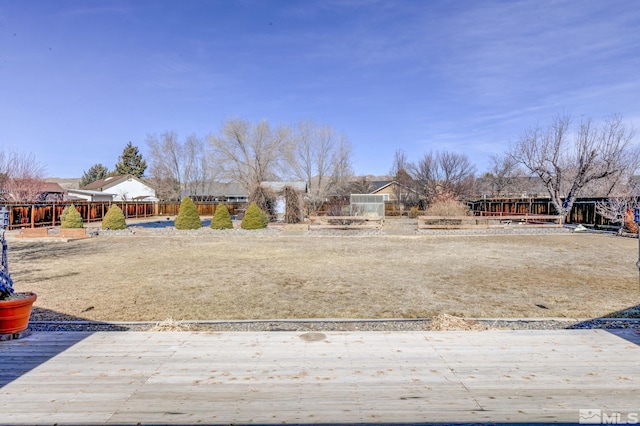 view of yard with a wooden deck and fence