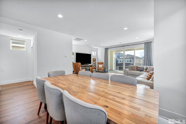 dining area featuring recessed lighting, baseboards, and wood finished floors