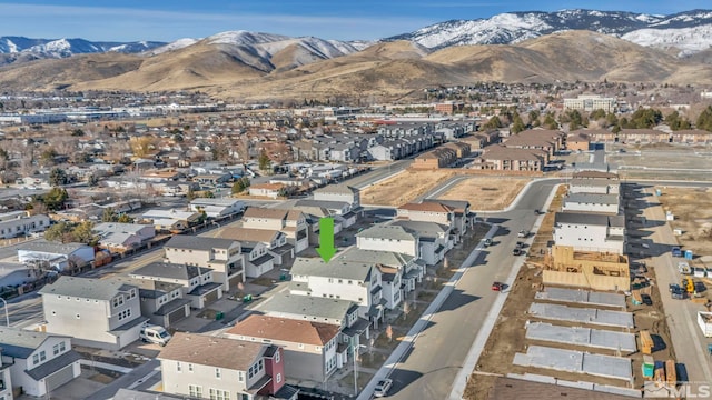 drone / aerial view featuring a residential view and a mountain view