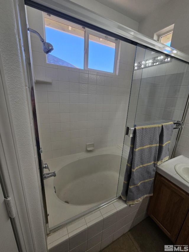 full bathroom featuring tiled shower / bath combo and vanity