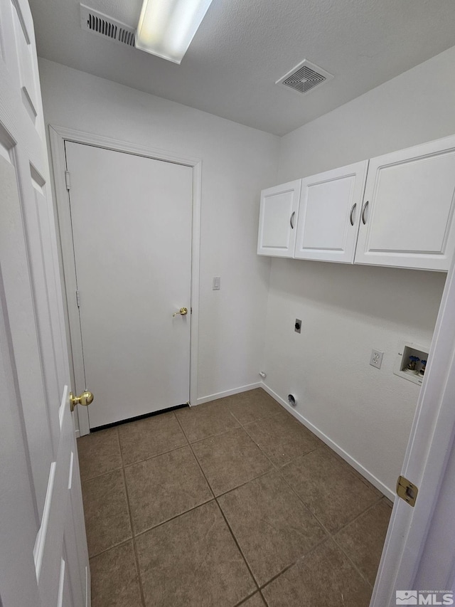 washroom featuring cabinet space, hookup for a washing machine, visible vents, and hookup for an electric dryer