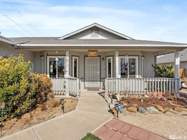 view of front of house featuring a shingled roof and a porch