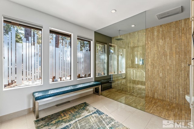 full bath featuring tile patterned flooring, recessed lighting, visible vents, baseboards, and walk in shower