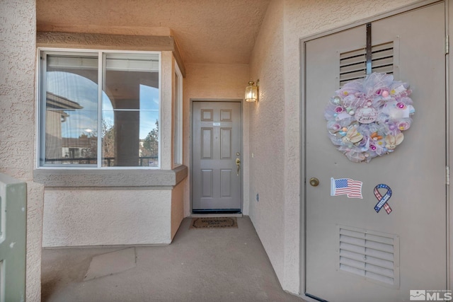 view of exterior entry with stucco siding