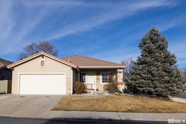 view of front of property with a garage, concrete driveway, a front lawn, and a tile roof