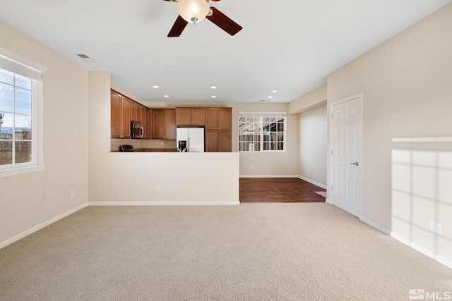 unfurnished living room featuring carpet floors, recessed lighting, visible vents, ceiling fan, and baseboards