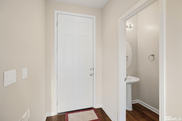 interior space with wood finished floors, visible vents, and baseboards