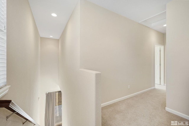 hall with baseboards, recessed lighting, and light colored carpet