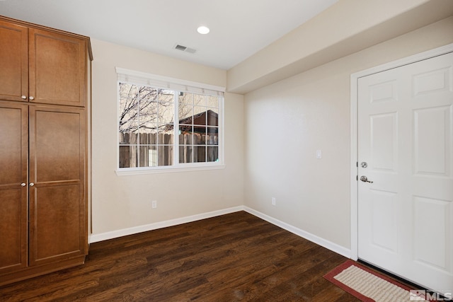 interior space with recessed lighting, visible vents, dark wood finished floors, and baseboards