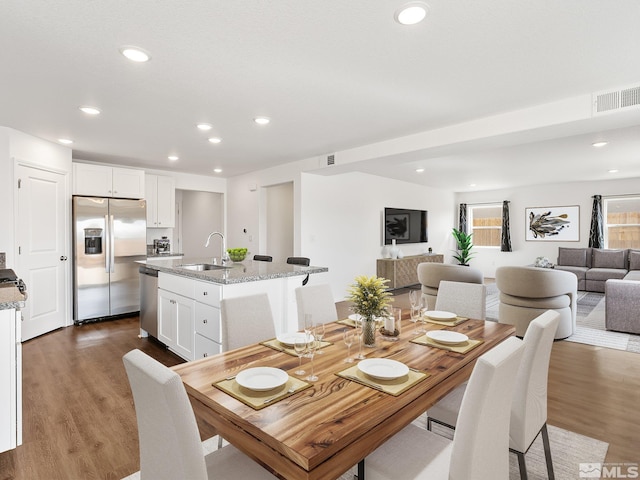 dining room with dark wood-style floors, recessed lighting, and visible vents