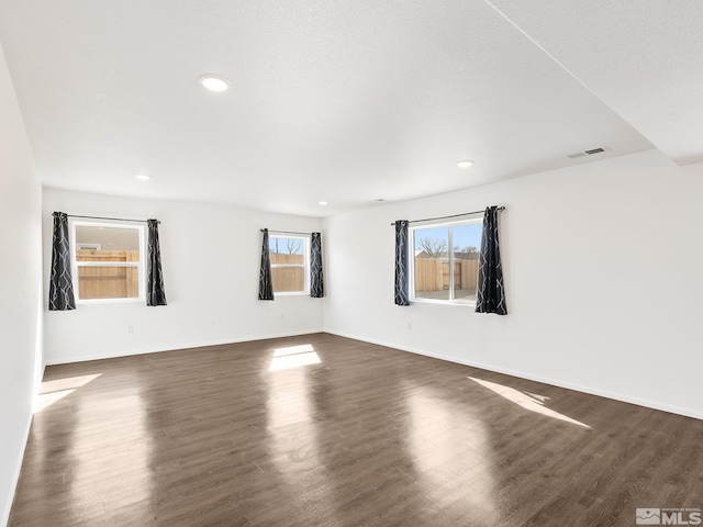 spare room with dark wood-style floors, recessed lighting, and baseboards