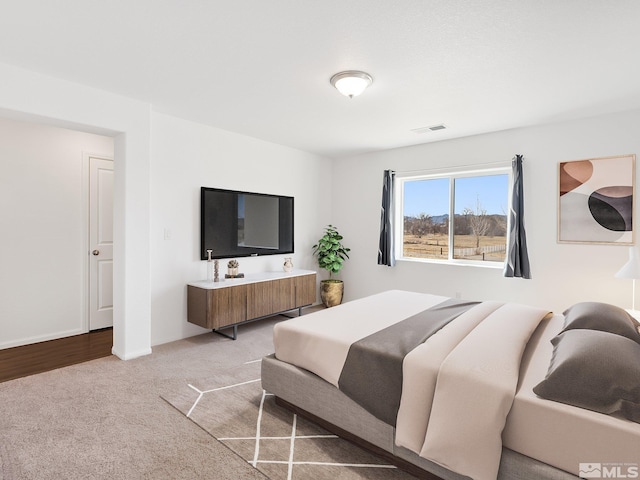 bedroom with light carpet, baseboards, and visible vents