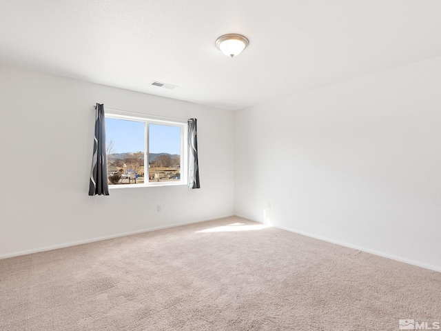 carpeted spare room with visible vents