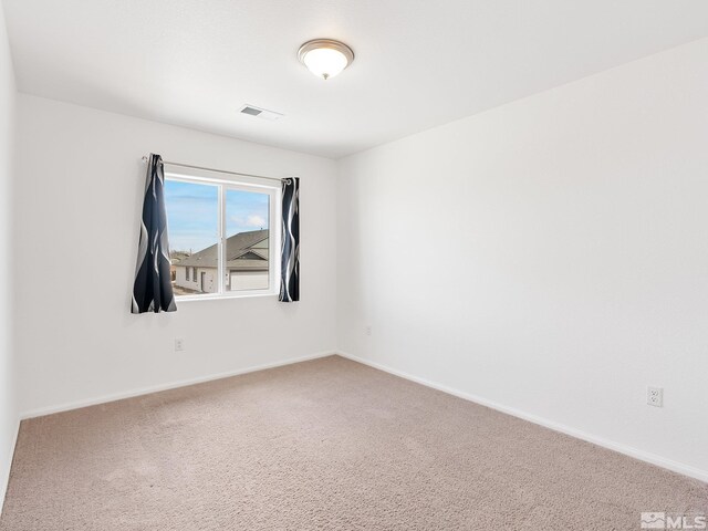 empty room with carpet and baseboards