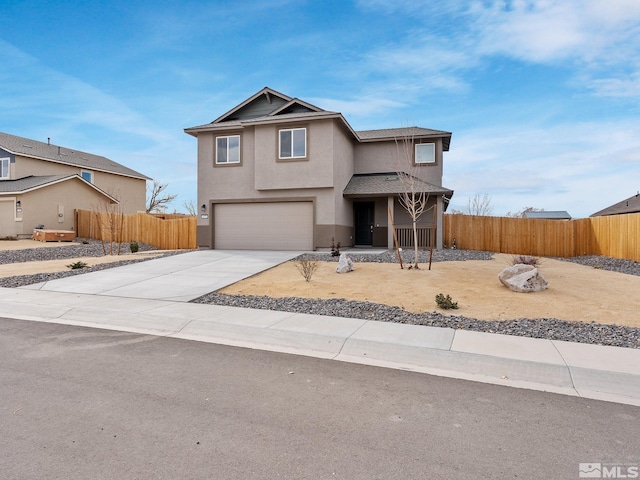 traditional home with concrete driveway, an attached garage, fence, and stucco siding