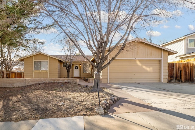 single story home featuring a garage, fence, and concrete driveway