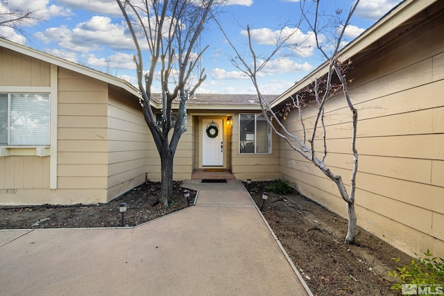 entrance to property with a patio area