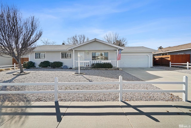 ranch-style home featuring a porch, driveway, a garage, and fence