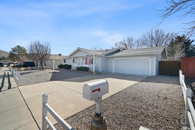 single story home with concrete driveway, a porch, an attached garage, and fence