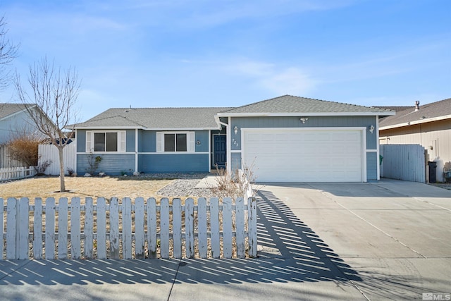 ranch-style house featuring a garage, concrete driveway, a shingled roof, and fence private yard