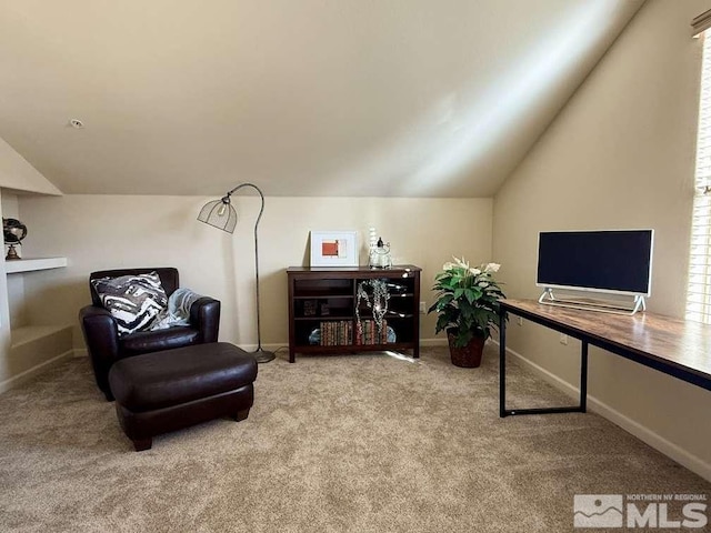 living area with carpet floors, baseboards, and vaulted ceiling