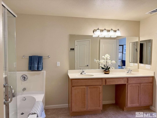 full bath featuring double vanity, visible vents, a sink, and a bath