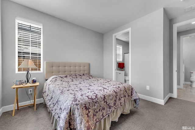 bedroom with carpet floors, visible vents, connected bathroom, and baseboards