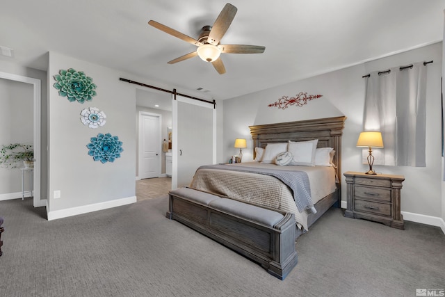 carpeted bedroom with a barn door, visible vents, baseboards, and a ceiling fan